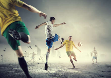 Football determined players outdoors fighting for ballの写真素材