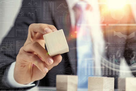 Close view of businessman making pyramid with empty wooden cubesの写真素材