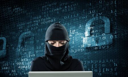 Hacker woman in dark clothes using laptop against digital background
