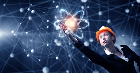 Engineer woman in helmet and global connection conceptの写真素材