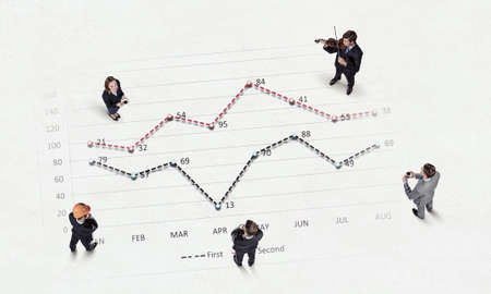 Top view of business people and graphs and diagrams on floorの写真素材