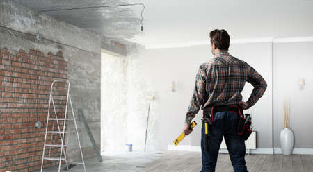 Builder man in checked shirt with tool belt on waistの写真素材