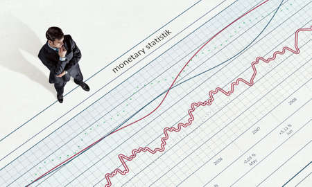 Top view of businessman and graphs and diagrams on floor