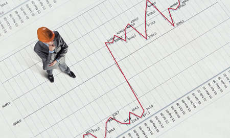 Top view of businessman and graphs and diagrams on floor