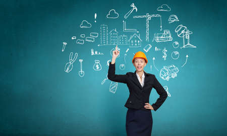 Young female engineer in suit and hardhatの写真素材