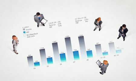 Top view of business people and graphs and diagrams on floor