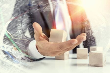 Close view of businessman making pyramid with empty wooden cubesの写真素材