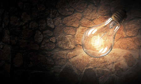 Power and energy concept with glass light bulb on brick wallの写真素材