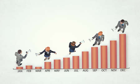 Top view of business people and graphs and diagrams on floor