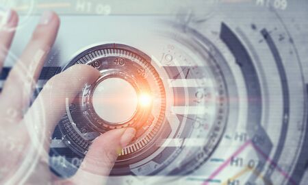 Hands of woman dialing numbers on safe padlockの写真素材