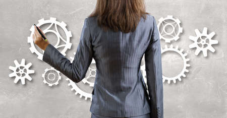 Businesswoman standing with back and drawing teamwork conceptの写真素材