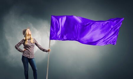 Young girl in casual with blank waving flag in handの写真素材