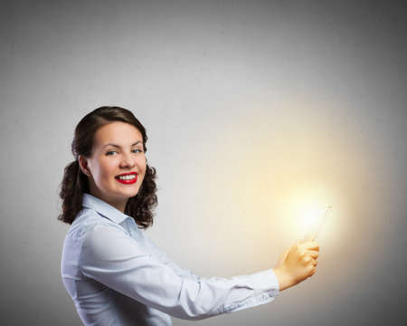 Confident young businesswoman working on digital tablet pcの写真素材