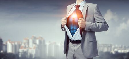 Office worker opening his shirt on chest like superheroの写真素材