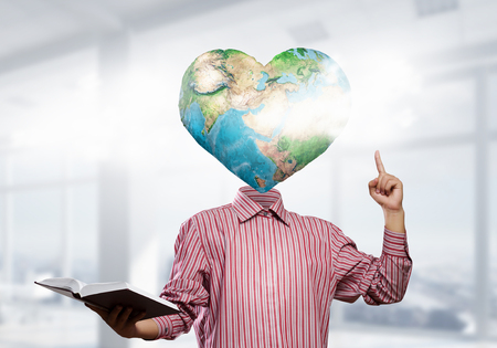 Businessman with globe for head. Elements of this image are furnished by NASAの写真素材