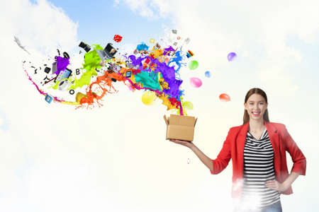Young woman in red jacket holding carton box in hand