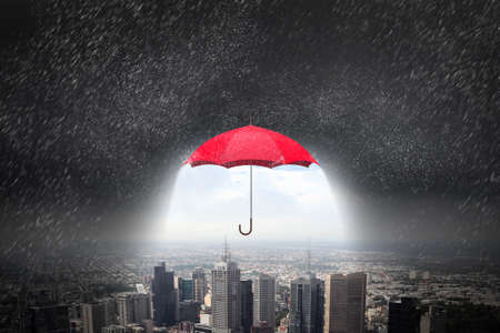 Conceptual image with color umbrella in sky under rainの写真素材