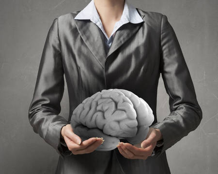 Close view of businesswoman holding in hands human mind conceptの写真素材