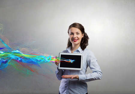 Confident young businesswoman working on digital tablet pcの写真素材