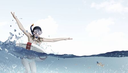 Kid girl in diving mask jumping in water