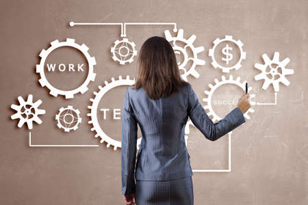Businesswoman standing with back and drawing teamwork conceptの写真素材