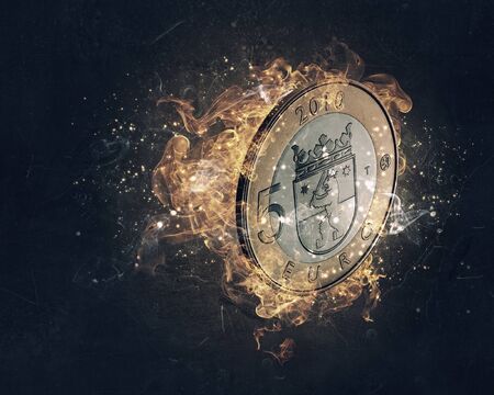 Five euro coin in fire flames on dark backgroundの写真素材