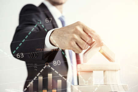 Close view of businessman making pyramid with empty wooden cubesの写真素材