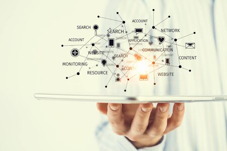 Hand of businessman holding touchpad pc presenting social network conceptの写真素材