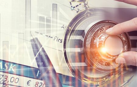 Hands of woman dialing numbers on safe padlockの写真素材