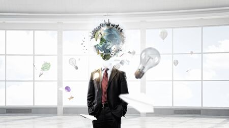 Businessman with globe for head. Elements of this image are furnished by NASAの写真素材