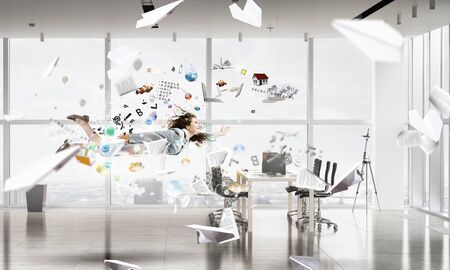 Young careless businesswoman flying in modern office interior