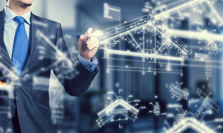 Male architect working with virtual construction planの写真素材