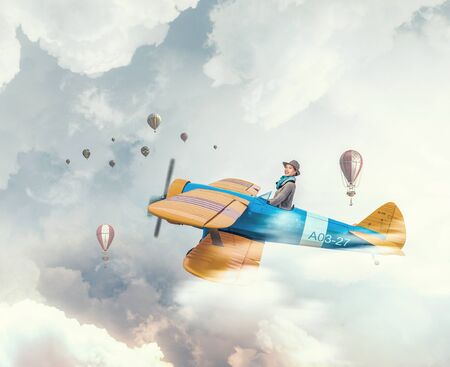 Young funny woman flying in air in retro airplane