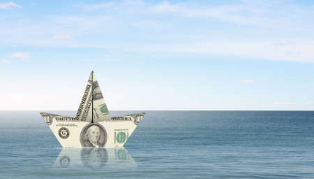Ship of dollar banknote floating on waterの写真素材
