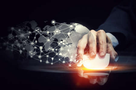 Hand of businessman on dark 3D rendering background using wireless mouse
