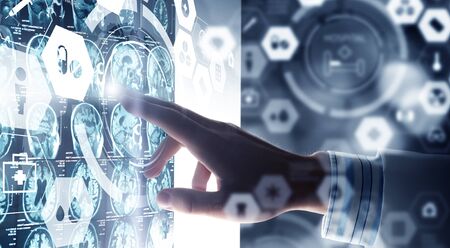 Hand of male doctor working with media screen