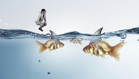 Businessman in diving mask jumping in waterの写真素材