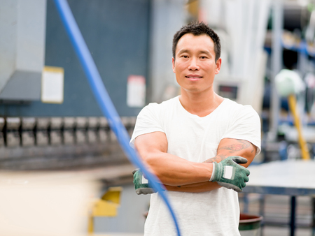 portrait of asian worker in production plant working on the factory floorの写真素材