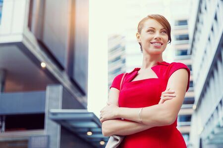 Portrait of beautiful business woman in red dressの写真素材