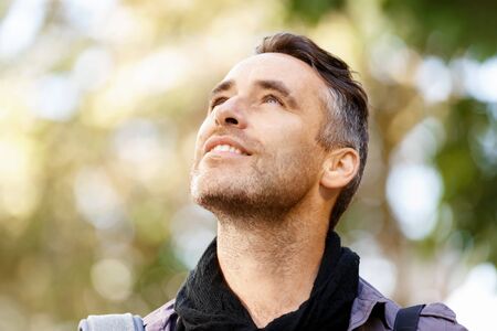 Happy male tourist in casual clothes in city walking