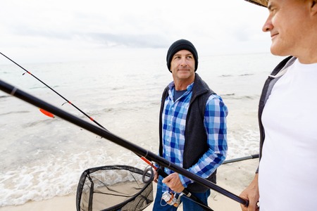Picture of fishermen fishing with rodsの写真素材