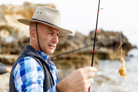Picture of fisherman fishing with rodsの写真素材
