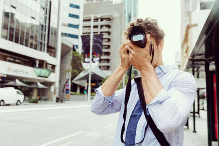 Professional photographer taking picture in cityの写真素材