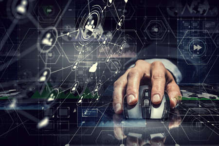 Hand of businessman on dark 3D rendering background using wireless mouseの写真素材