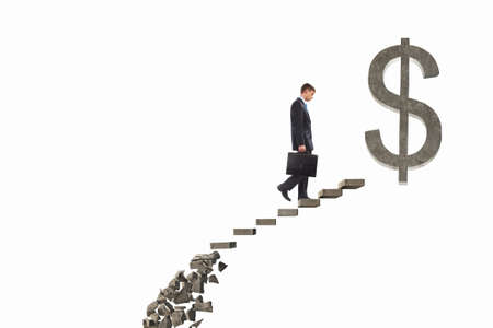 Businessman climbs steps of collapsing financial ladderの写真素材