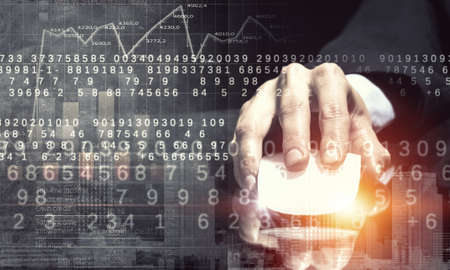 Hand of businessman on dark 3D rendering background using wireless mouseの写真素材