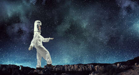 Young woman with carton box on head imagine she is astronautの写真素材