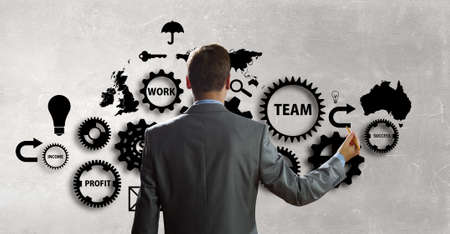 Businessman standing with back and drawing teamwork conceptの写真素材