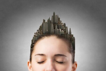 Girl with scyscrappers on head. Comceptual imageの写真素材