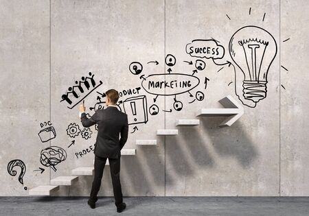 Businessman spraying his business ideas from aerosol canの写真素材